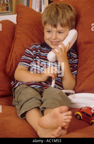 Young boy using telephone Stock Photo