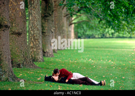 A couple kiss in St James Park in London. Stock Photo