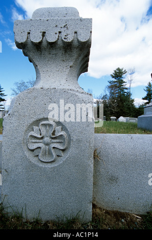 Granite wall around a Old Headstone in a New England graveyard cemetery located in New Hampshire USA vertical Stock Photo