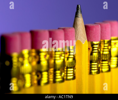 row of cheap pencil with rubbers on the end one turned around Stock Photo