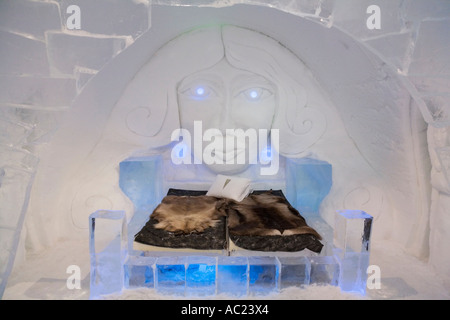 A bed covered with reindeer skins in a bedroom of the Jukkasjarvi icehotel Stock Photo