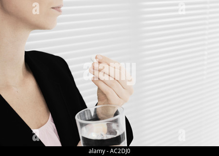 Businesswoman Taking Medication Stock Photo