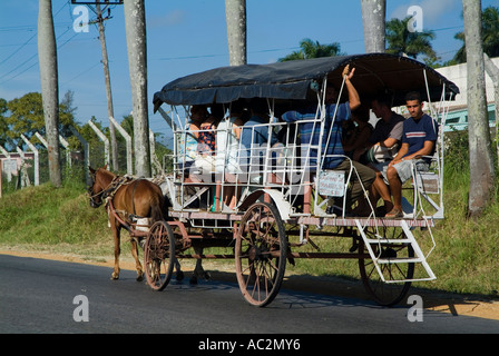 Horse pulling a taxi cart filled with people on a road outside Pinar del Rio, Cuba. Stock Photo