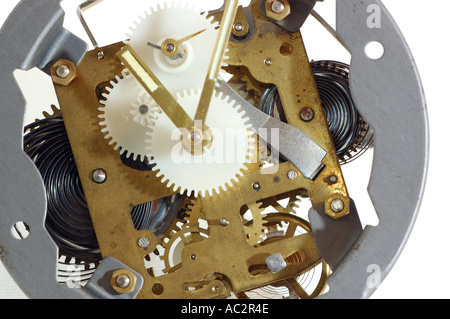 Inner working parts of an old windup clock on white background Stock Photo