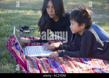 Asian mother and son doing homework together Stock Photo