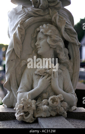 Marble statue of a woman holding flowers at Père-Lachaise Cemetery in Paris, France. Stock Photo