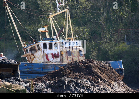 Old trawler dragged up onto bank of River Eske near Whitby. Stock Photo