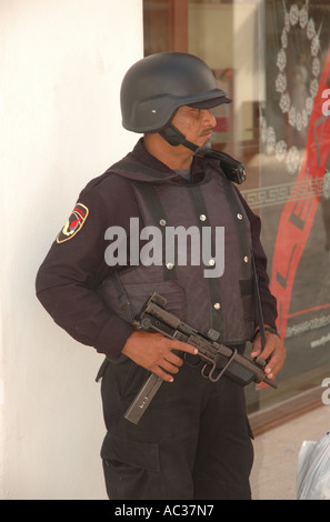 A police officer stands guard on a street in Playa del Carmen,  Mexico. Stock Photo