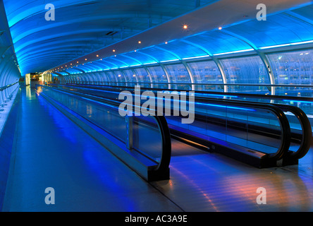 Passenger corridor and escalator at dawn between terminals 1 and 2 at Manchester Airport, UK Stock Photo