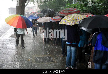 People queuing in a summer rain storm for Madame Tussaud's on Marylebone Road in London Stock Photo