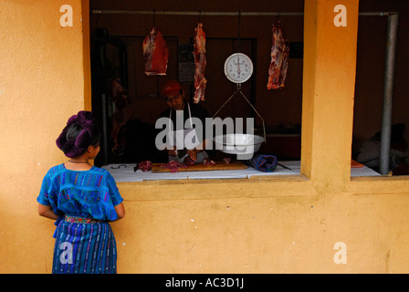Mayan indigenous girl waiting in front of the butcher shop, San Antonio Palopo, Lake Atitlan, Guatemala, Central America Stock Photo