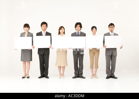 Business people holding blank placards Stock Photo