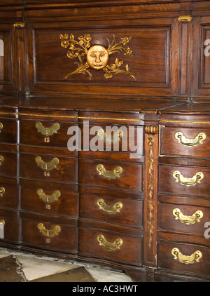 Moon with face motif on walnut cabinet with drawers where priests vestments are kept in the Sacristy Cathedral Granada Spain Stock Photo