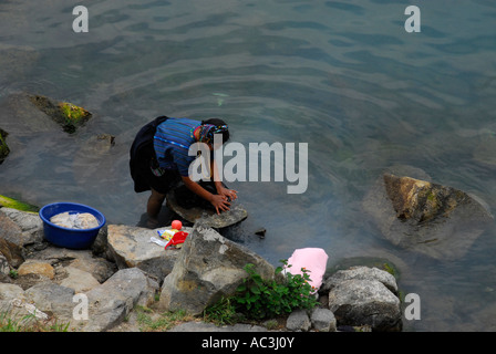 Indigenous woman washing clothes in the lake, Santiago de Atitlan, Lake Atitlan, Guatemala, Central America Stock Photo