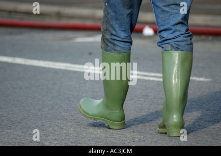 A person wearing a pair of traditional green rubber wellington boots in ...