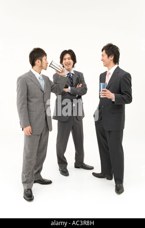 Three businessmen drinking and talking Stock Photo