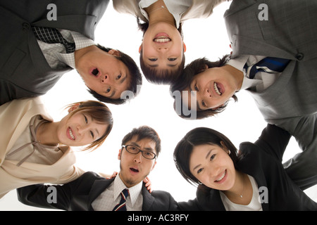 Business people huddled in circle Stock Photo