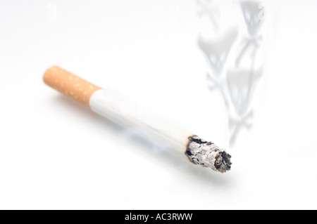 Ciggarette on a white background with smoke in the shape of skull and cross bones Stock Photo