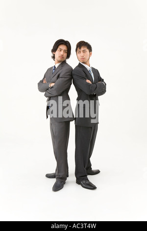 Two businessmen standing back to back Stock Photo