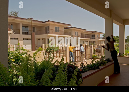 Black African man about to shake hands to welcome visitor outside his home in a modern housing development Accra Ghana Africa, Stock Photo