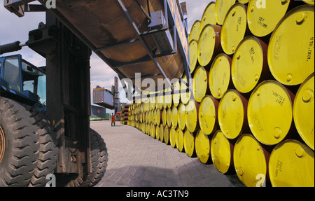 Loading and offloading oil drums at port dockside Stock Photo