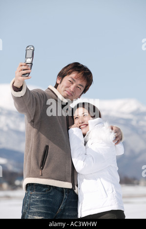 Young couple taking photo with mobile phone Stock Photo