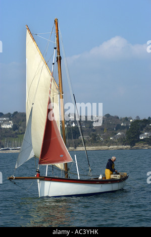 A traditional oyster dredger sailing boat at work in Carrick Roads in the Fal estuary Cornwall England Stock Photo