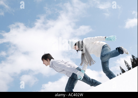 Young couple walking in snow Stock Photo