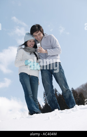 Young couple using mobile phone Stock Photo