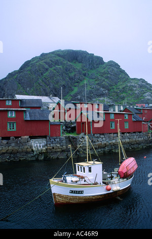 Red wooden houses around a fjord Lofoten islands archipelago in Nordland county northern Norway Scandinavia Europe Stock Photo