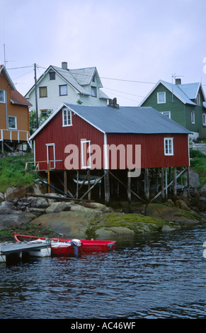 Red wooden house on stilts on a fjord Lofoten islands archipelago in Nordland county northern Norway Scandinavia Europe Stock Photo