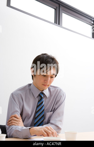 Young businessman looking at document Stock Photo