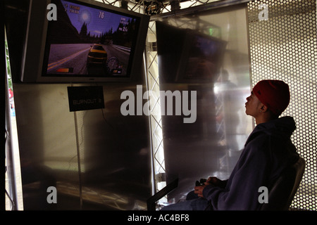 Young man playing on a playstation plasma screen. Stock Photo