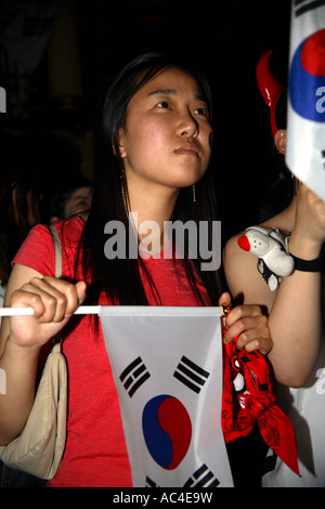 South Korean (Republic) fans anxiously await final whistle during 2006 World Cup Finals draw vs France, Cafe de Paris, London Stock Photo