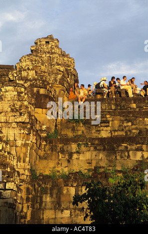 Tourists watch the Golden Sunset from Phnom Bakheng Angkor Wat Cambodia Stock Photo