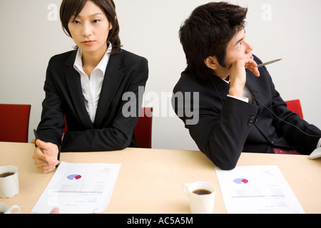 Young businessman bored during meeting Stock Photo