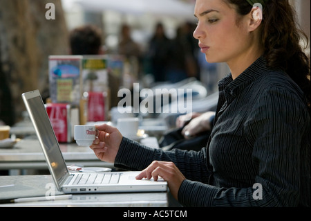 Woman using laptop in street cafe Stock Photo