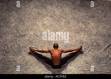 African American male dancer stretching African American male dancer stretching Portrait Horizontal Color Brown View From Above Stock Photo
