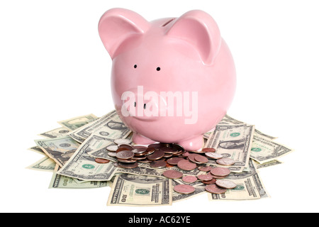 Pink piggy bank sitting on pile of money Stock Photo