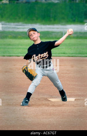 Little League baseball pitcher player throwing a baseball Stock Photo