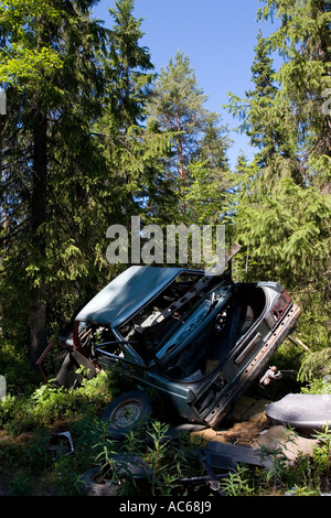 Car wreck in the forest , Finland Stock Photo