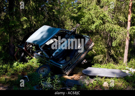 Car wreck in the forest , Finland Stock Photo