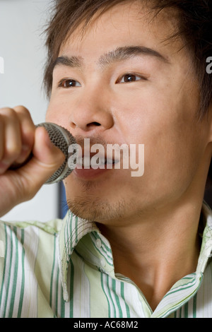 young man sings on microphone Stock Photo