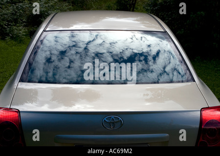 Sky and clouds reflecting from car rear window , Finland Stock Photo