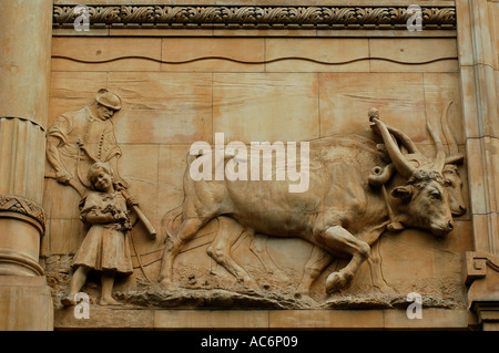 Bas relief depicting a farmer lowing the field with a cow decorating exterior of a building in Kiss utca street downtown Budapest Hungary Stock Photo