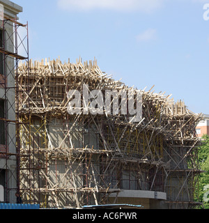 Intricate structure of temporary timber formwork & scaffolding around new concrete structure on construction building site Tirana Republic of Albania Stock Photo
