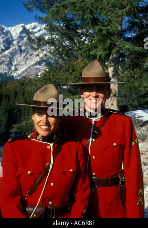 adult man and woman male and female Royal Canadian Mounted Police RCMP aka Canadian Mounties on duty in Canadian Rockies in Banff in Alberta Canada Stock Photo