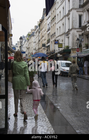 Pedestrian with umbrella in rainy Paris Stock Photo - Alamy