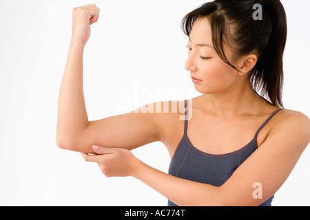 Woman pinching her arm Stock Photo