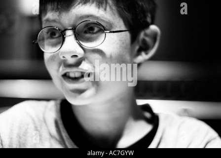 Black and white portrait of a young smiling boy who looks similar to Harry Potter Stock Photo